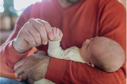Close-up of father holding his, a Person Photo by HalfPoint