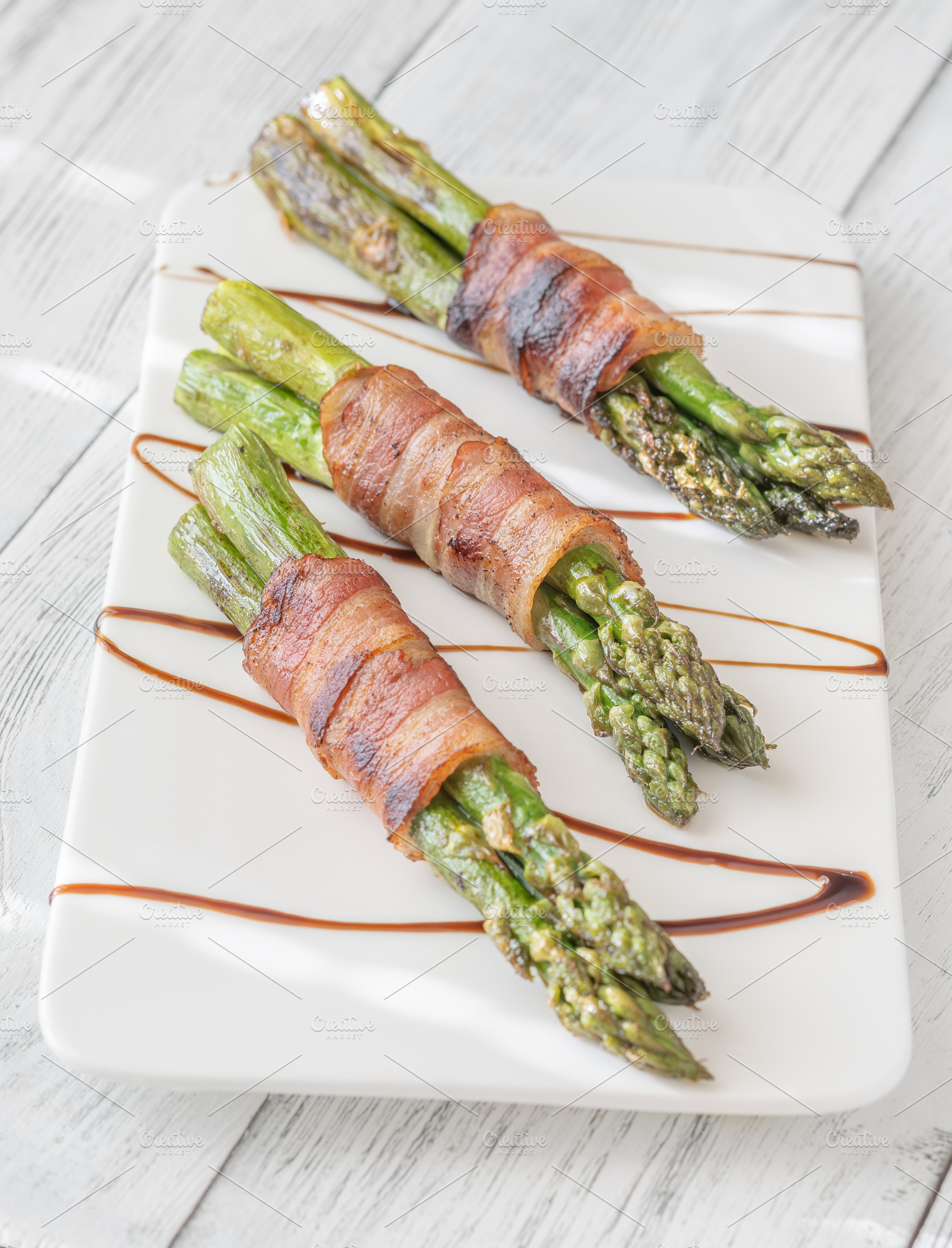 Gourmet Bacon Wrapped Asparagus With Balsamic Glaze On White Cer, a Food & Drink Photo by Alexander Prokopenko