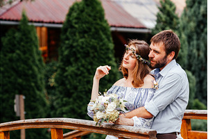 Eclectic rustic wedding couple stand