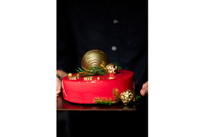 Festive Red Cake Adorned With Golden, a Holiday Photo by IlliaBondarPhotography