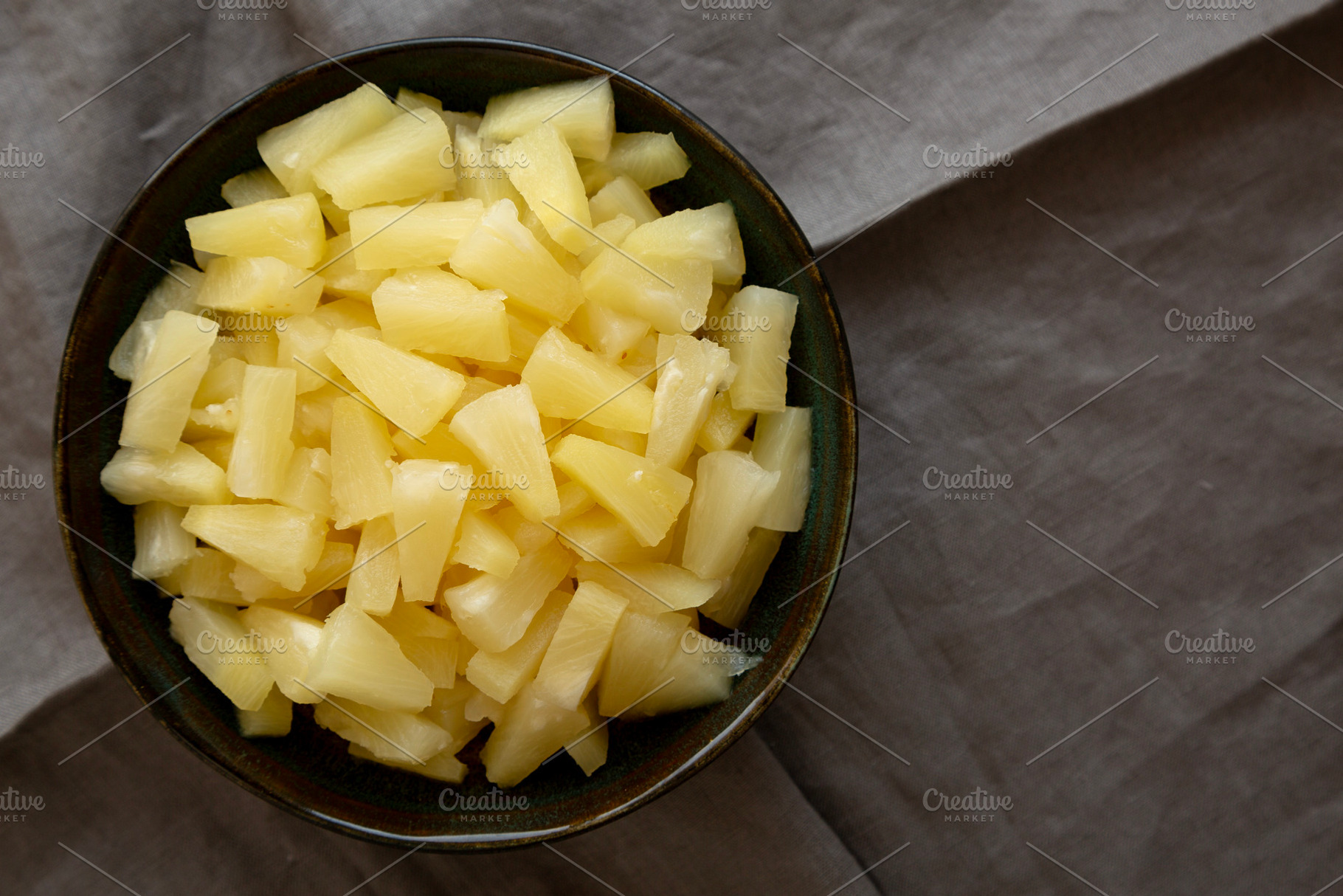 Canned Pineapple Tidbit Chunks in a Bowl, top view. Copy space., a Food & Drink Photo by LiudmylaChuhunova