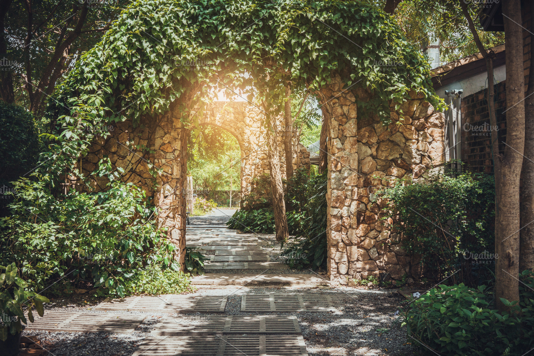 Stone arch entrance wall featuring garden, gate, and arch, an Architecture Photo by Nednapa