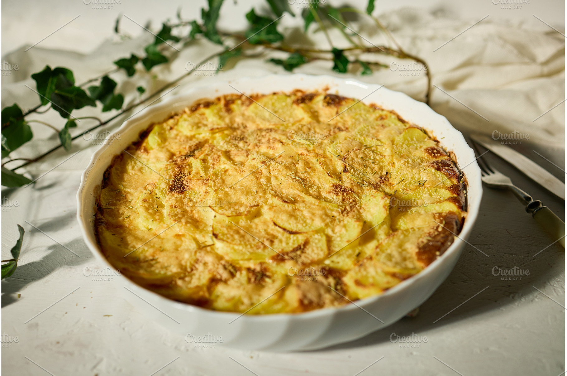 Golden gratin on a rustic table., a Food & Drink Photo by IlliaBondarPhotography