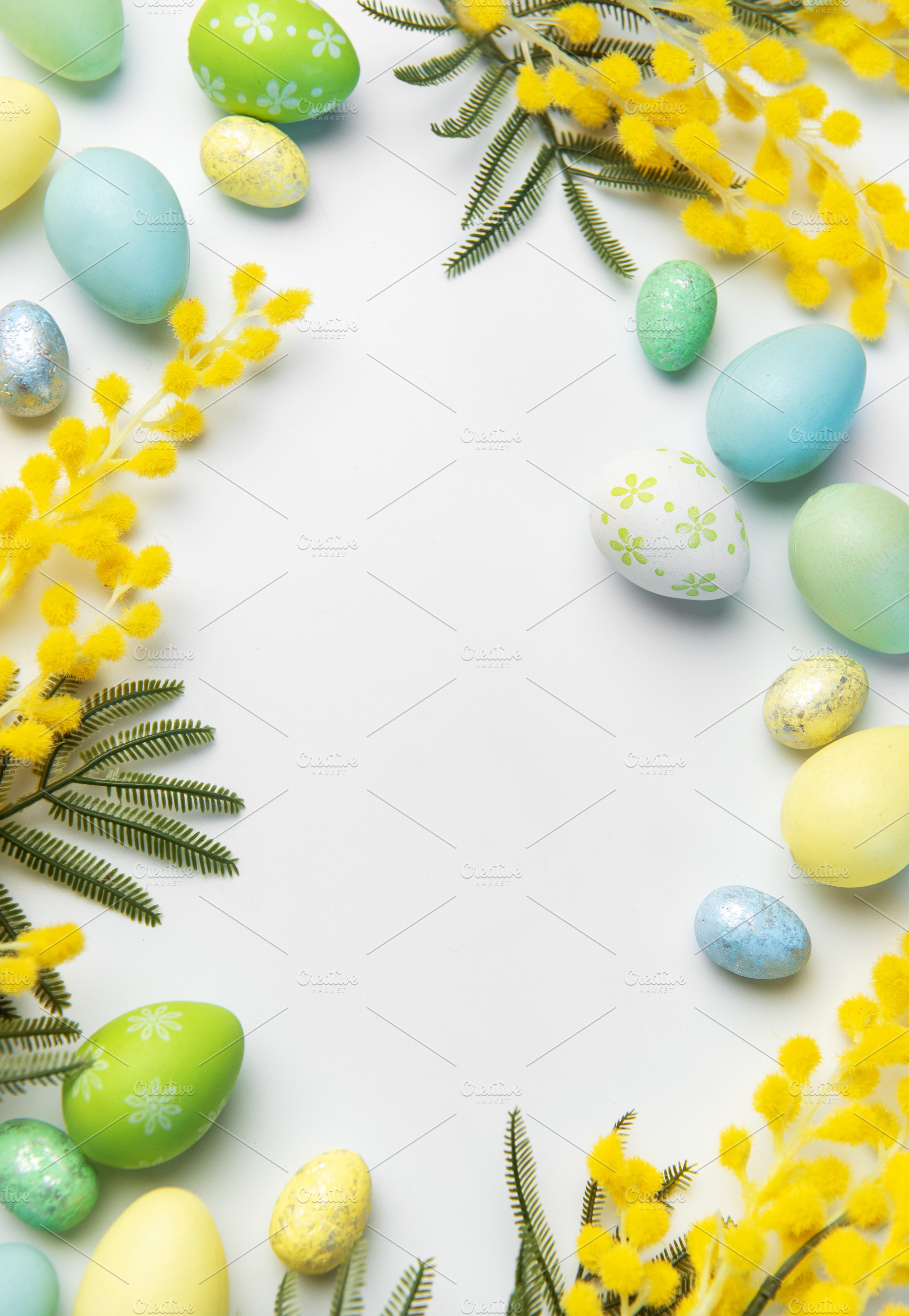 Easter eggs and mimosa flowers creating spring frame, a Holiday Photo by Olena Rudo