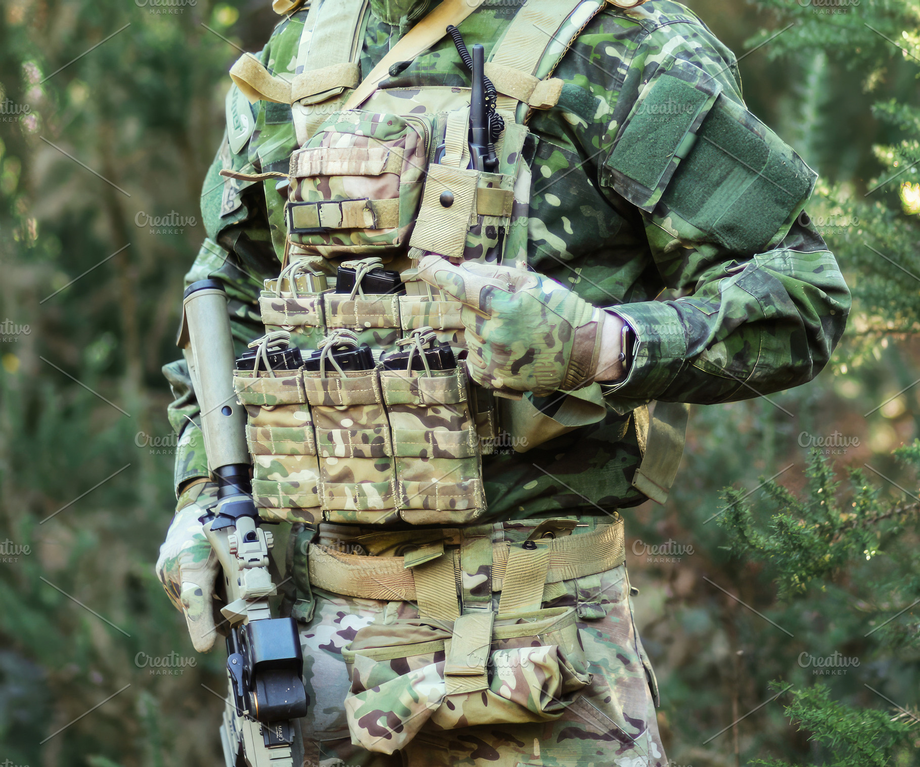 Soldier wearing camouflage uniform and tactical vest pointing at ammunition mag, a Sports & Recreation Photo by Antonio Gravante Market