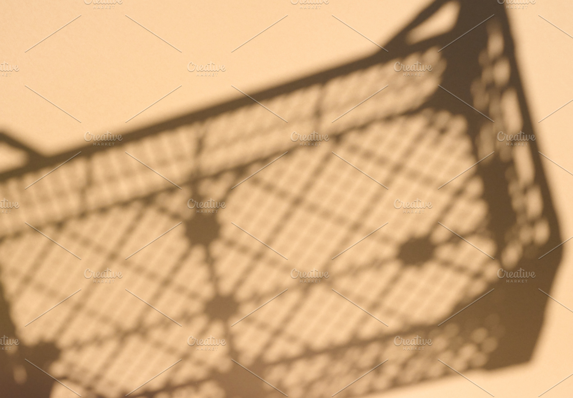 Sharp shadow of a plastic crate or lattice box on a light wall, an Abstract Photo by ndanko