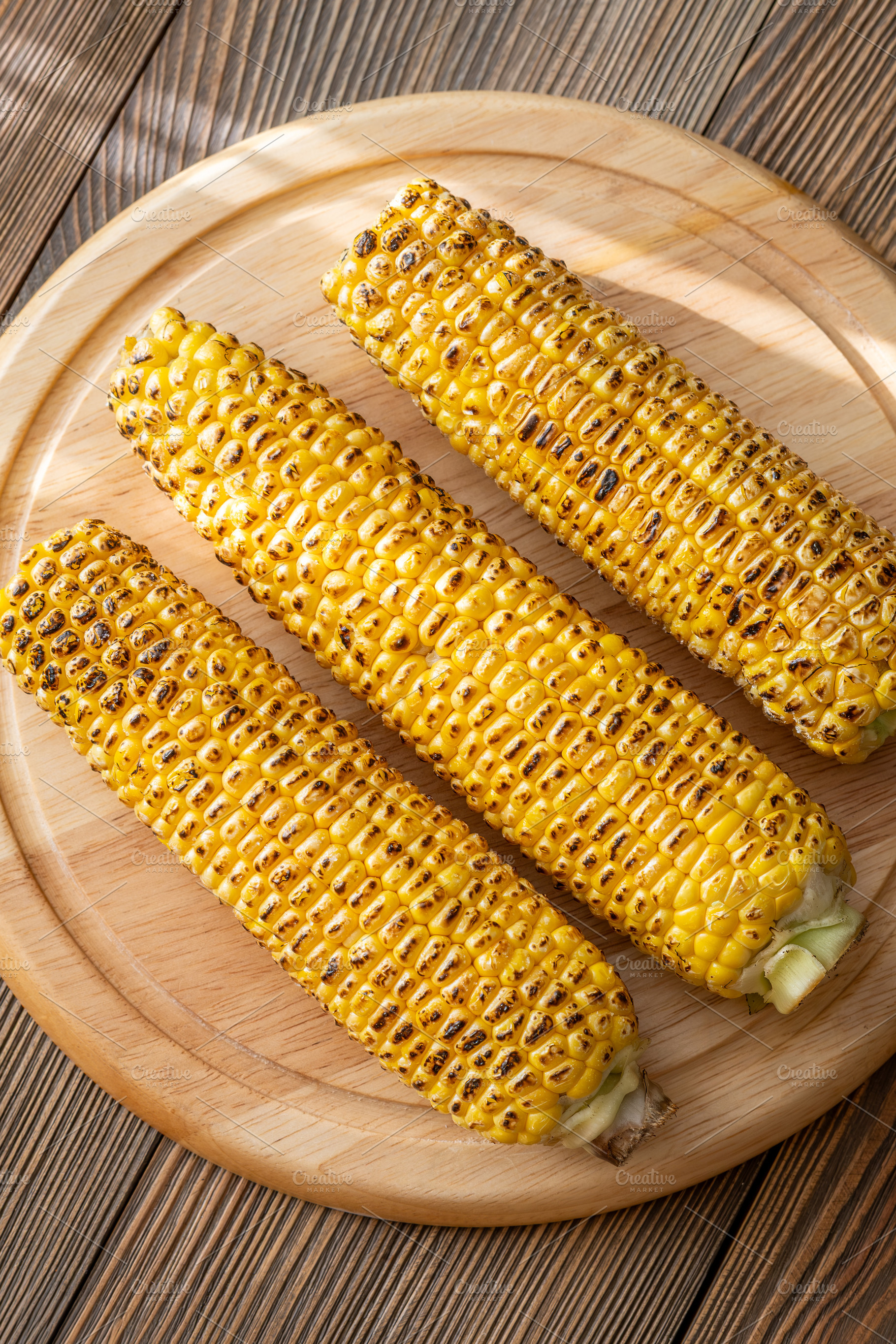 Three grilled corn cobs, a Food & Drink Photo by Alexander Prokopenko
