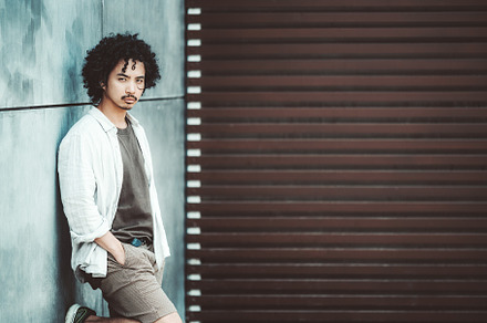 Casual man leaning by modern wall, a Person Photo by SkyNext