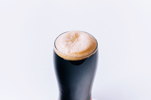Glass of stout beer containing stout, beer, and guiness