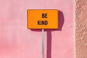 Sign with phrase Be Kind on color city street wall in urban sett, a Photo by Dvoevnore photos