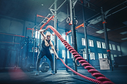 Woman with battle rope battle ropes exercise in the fitness gym featuring, a Sports & Recreation Photo by Volodymyr Melnyk