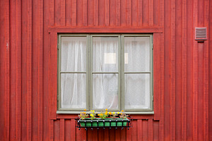 Old window of red color wooden house