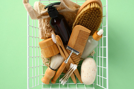 Natural organic SPA cosmetics and accessories in basket on green background, a Beauty & Fashion Photo by photoguns