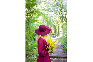 girl in hat with a bouquet of yellow, a Nature Photo by Artsaba Family