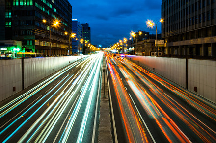 Busy street in the city at dusk full of car light streaks dynamic blue hour, a Transportation Photo by Igor Sch Photo