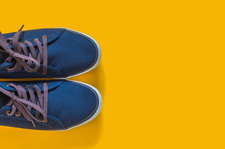 Blue sneakers on yellow background featuring background, sneakers, and sport