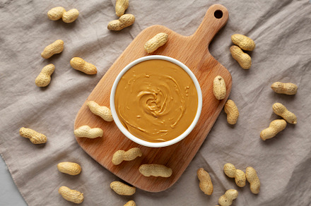 Organic Peanut Butter in a Bowl, top view. Flat lay, overhead.