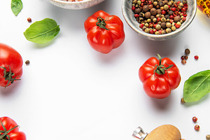 Fresh tomatoes, herbs, and spices on white background, a Food & Drink Photo by Olena Rudo