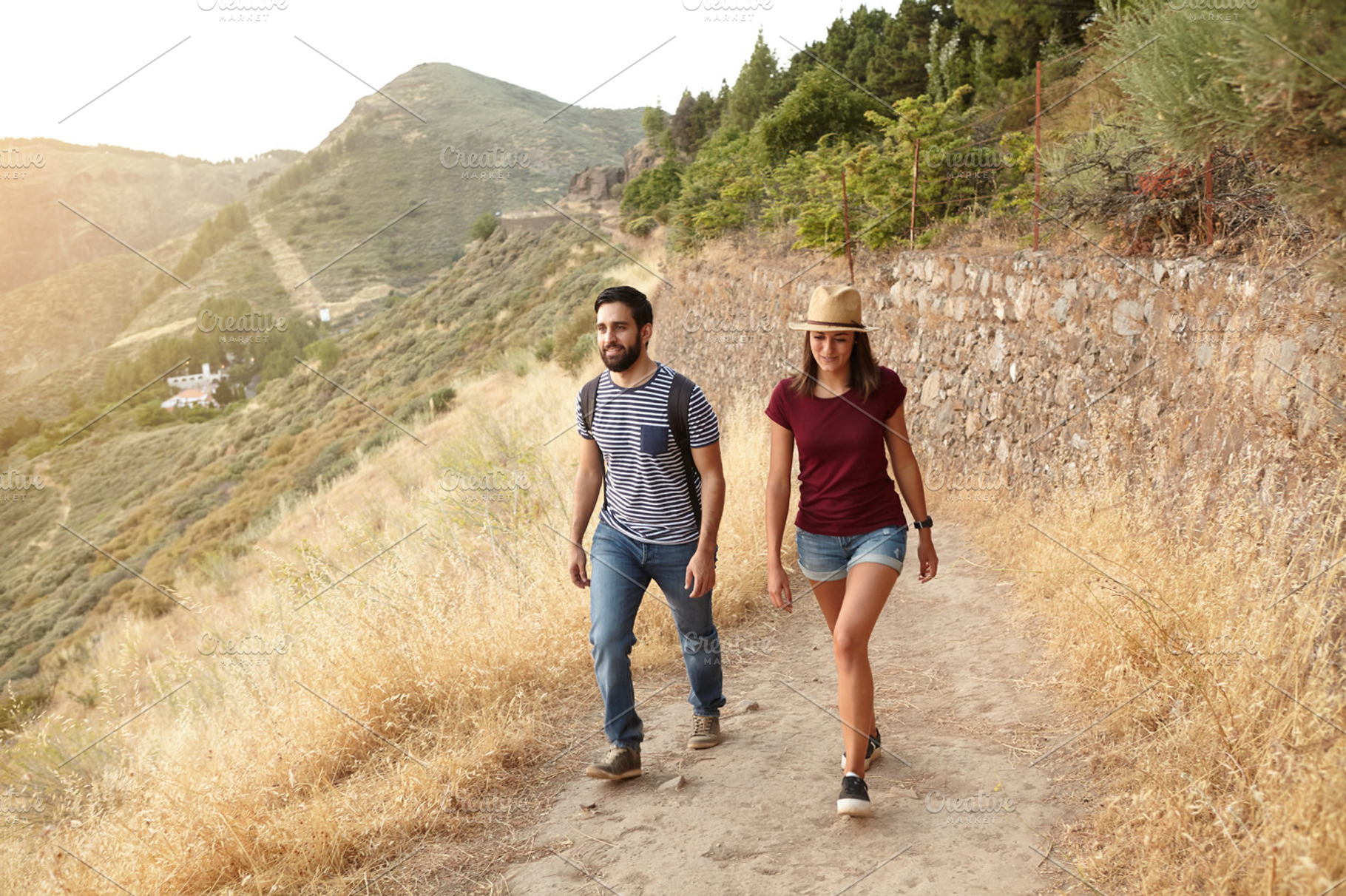 Walking at sunset containing young, couple, and sunlight, a Person Photo by Coco Images