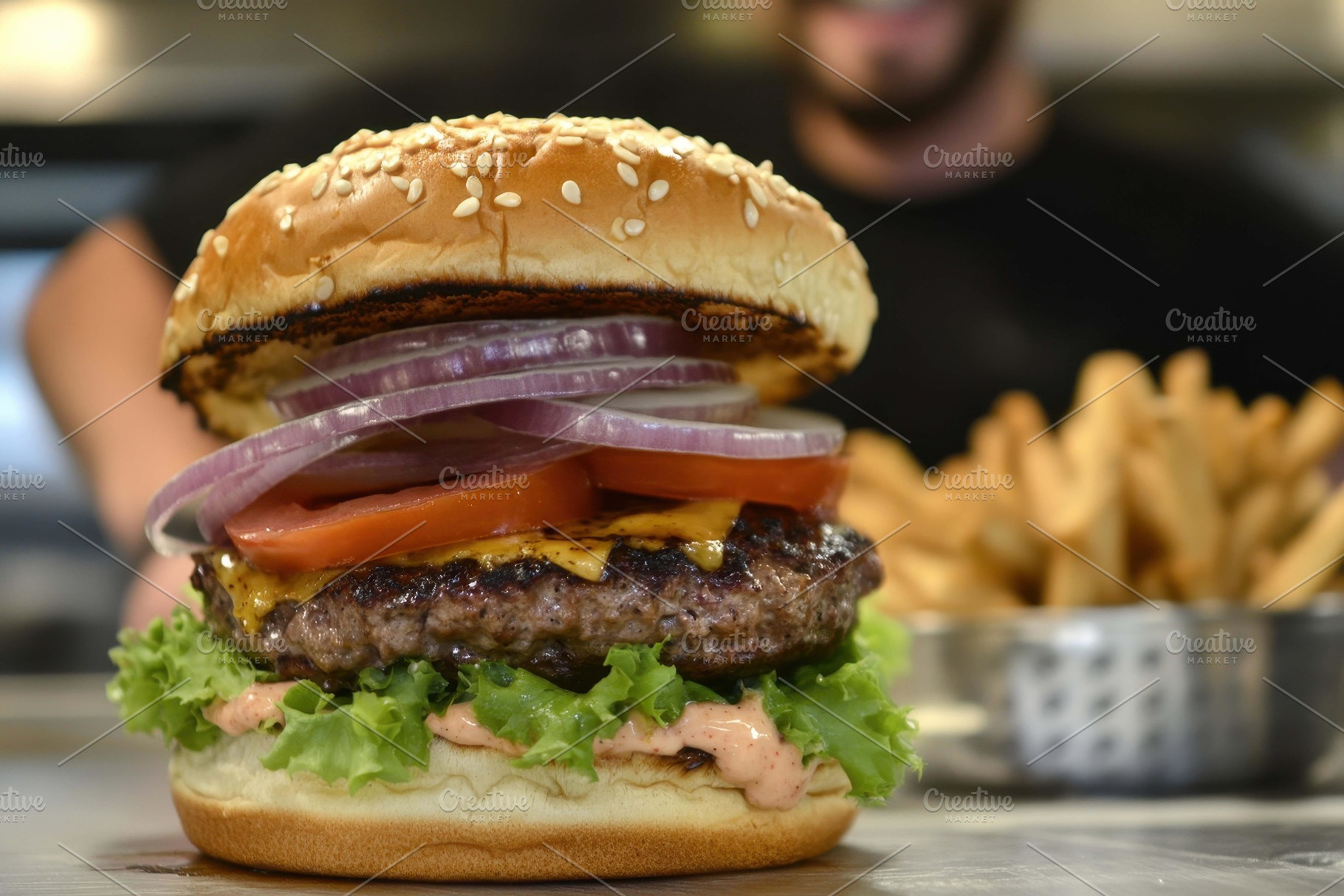 Juicy cheeseburger served with crisp, a Photo by Tanuart