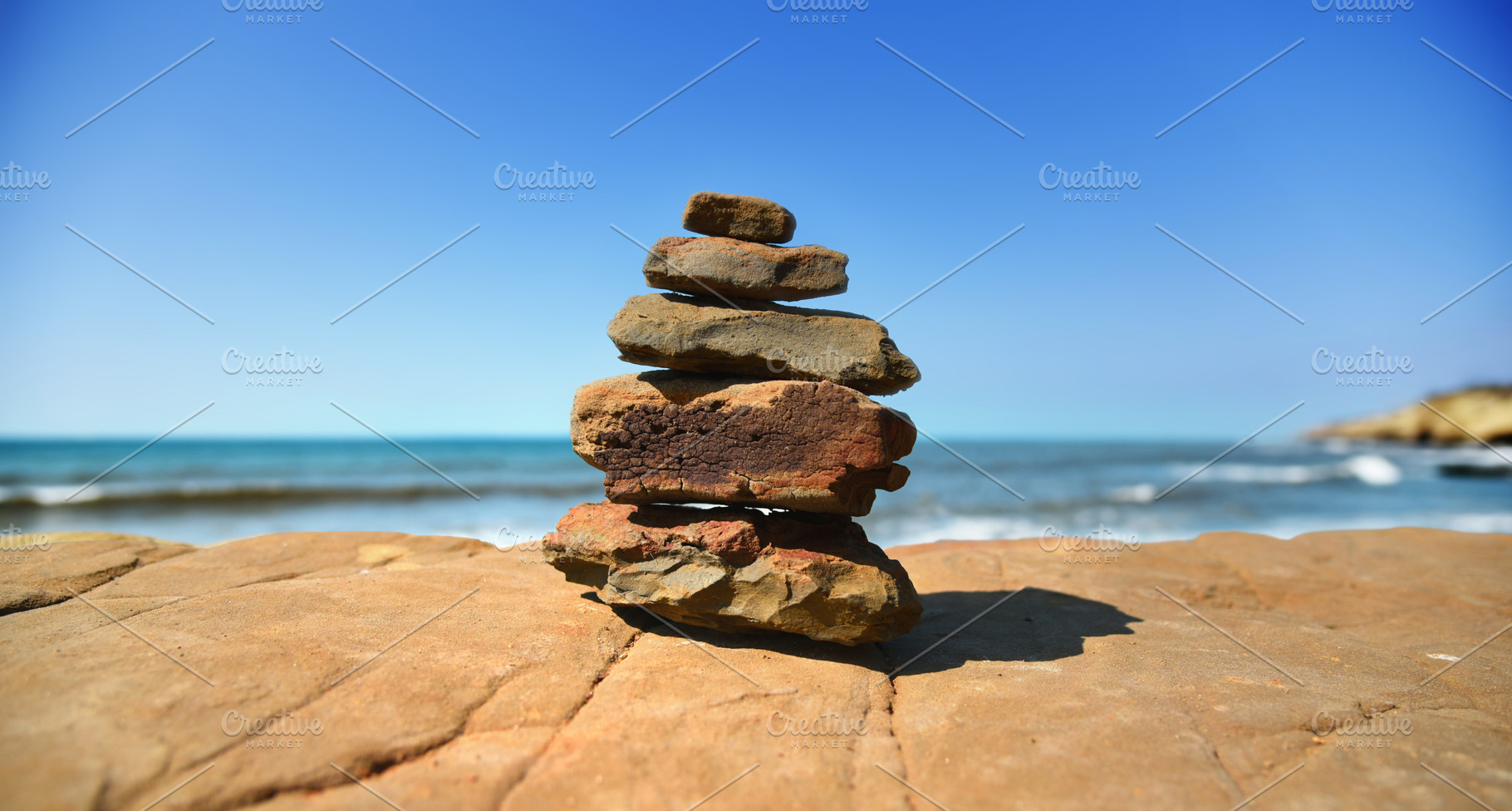 Beach Cairn Rock Stack with Blue Sky, a Background Photo by kristiangallagher
