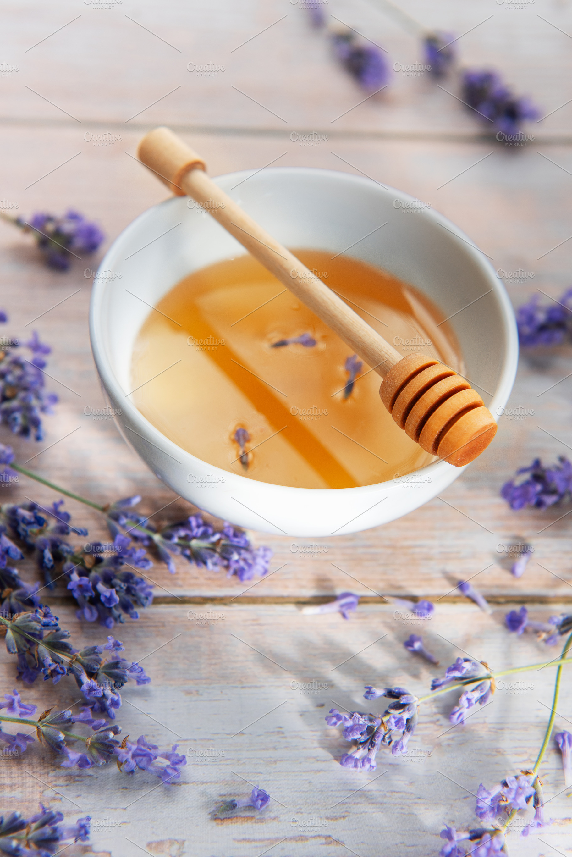 Honey in bowl with lavender flowers and dipper, a Food & Drink Photo by Olena Rudo