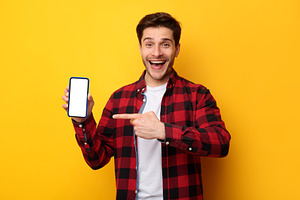 Man showing white empty smartphone screen and pointing finger