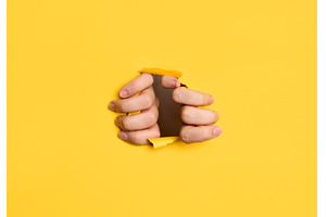Human hands tearing yellow paper, an Abstract Photo by Gladkov photography