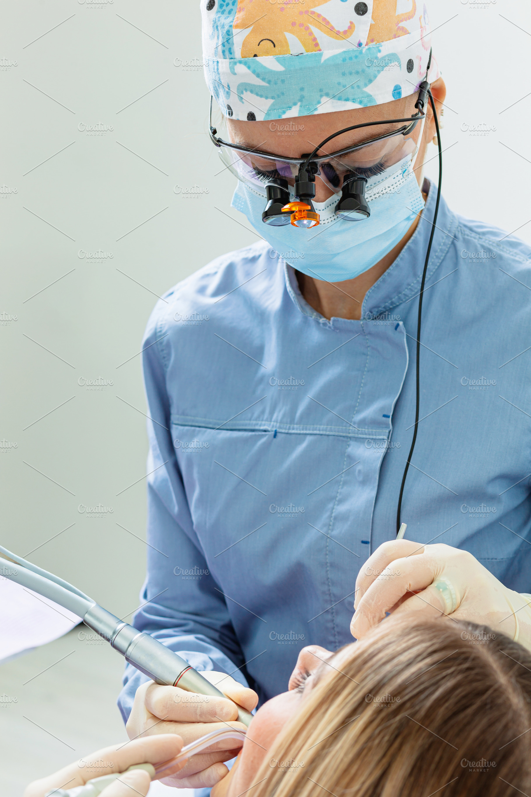 Dentist performing dental checkup using professional tools on female patient, a Health & Medical Photo by Antonio Gravante Market