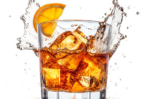 Cocktail glass splashing with ice cubes, a Photo by Grafvision photography