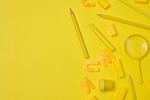 Assortment of yellow stationery and creative items scattered on, a School & Education Photo by ndanko