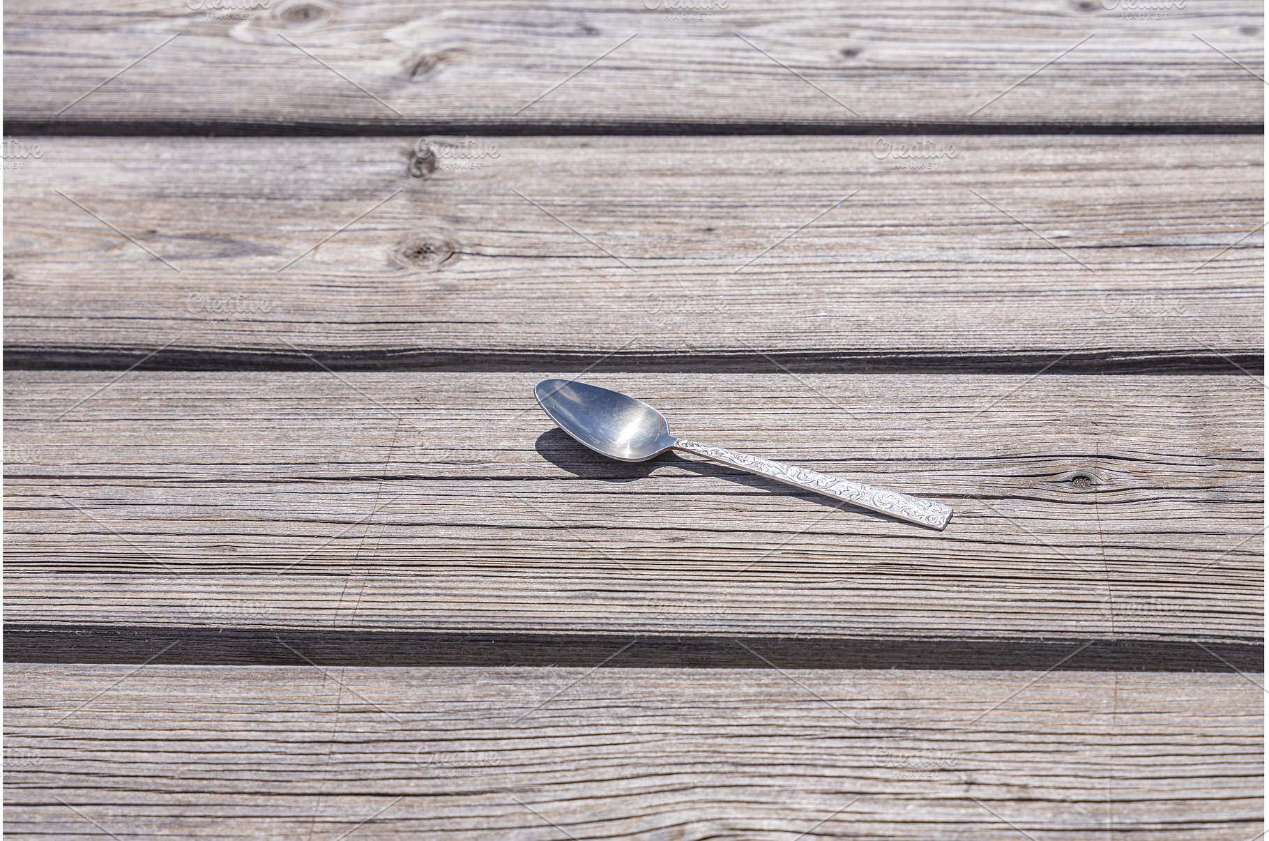 One metal spoon is on the gray, a Food & Drink Photo by Illustrations&photos