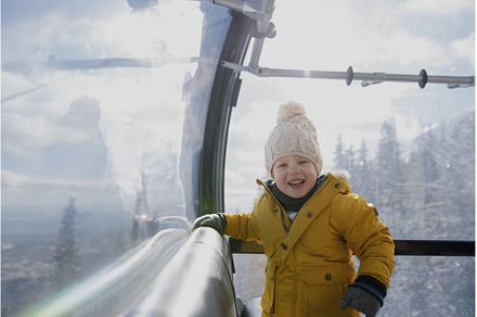 Little boy riding cable car to the, a Holiday Photo by HalfPoint