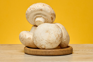 Fresh champignons with white caps and light brown stems, arrange, a Food & Drink Photo by ndanko