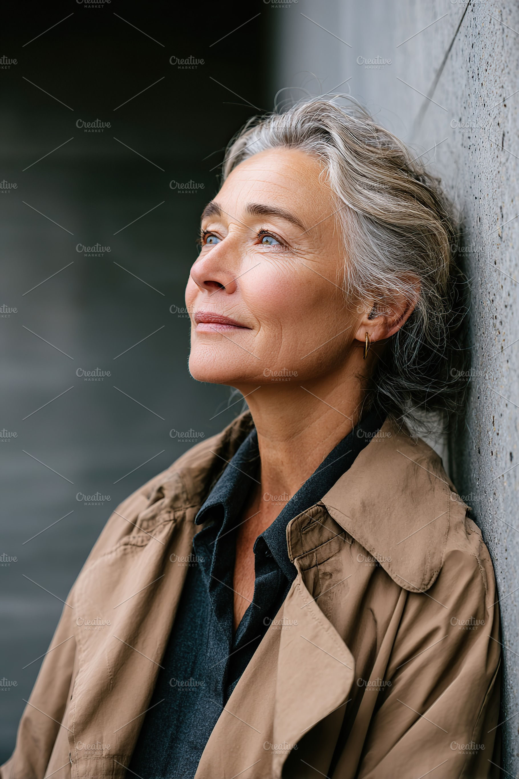 Mature woman with minimal makeup gazes thoughtfully in an urban setting during, a Person Photo by AlyaAnd