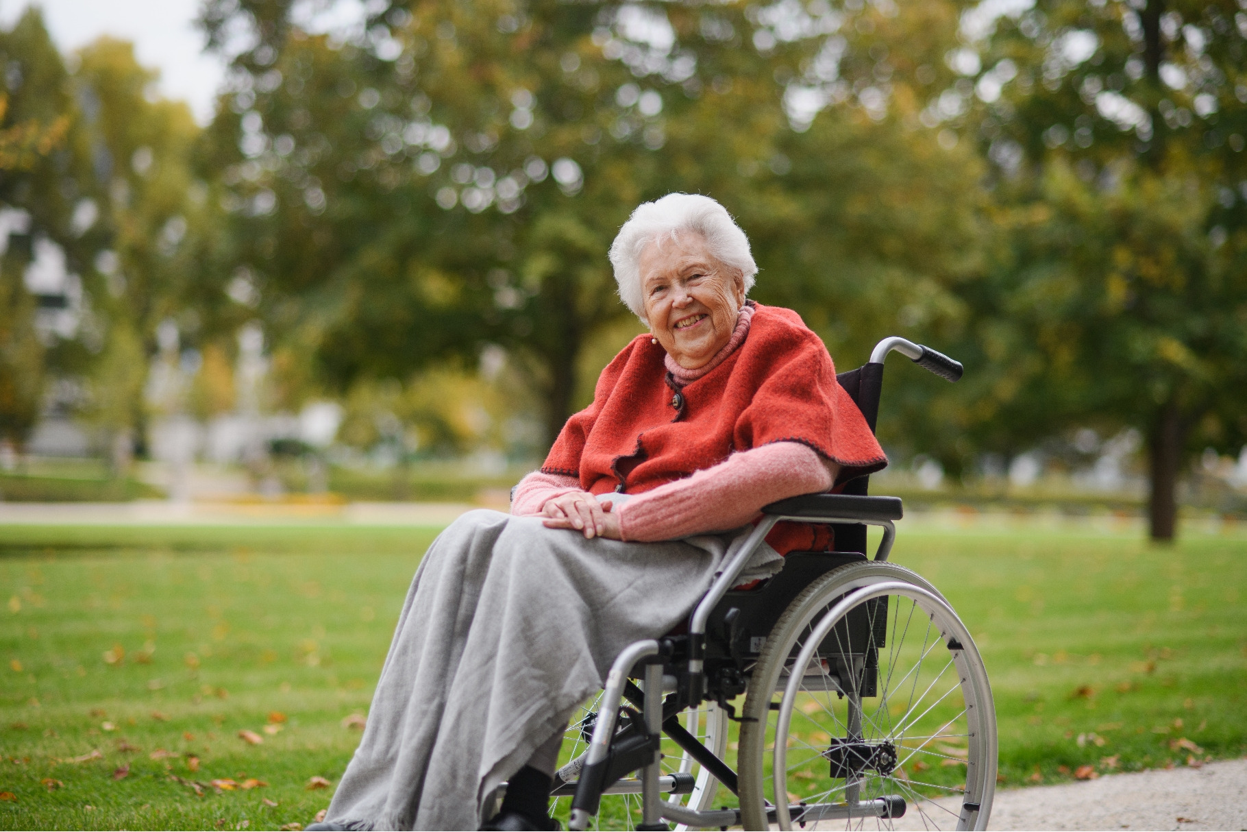 Portrait of elderly woman sitting in, a Nature Photo by HalfPoint