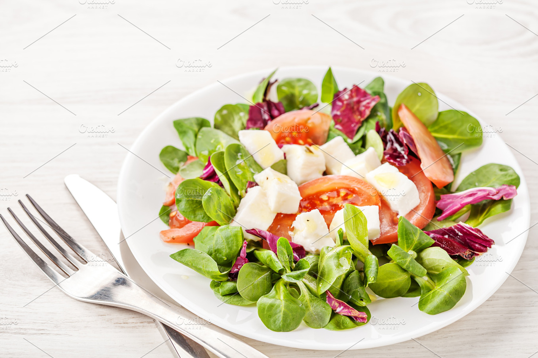 Fresh Summer Salad On White Table Featuring Appetizer Bowl And Cheese