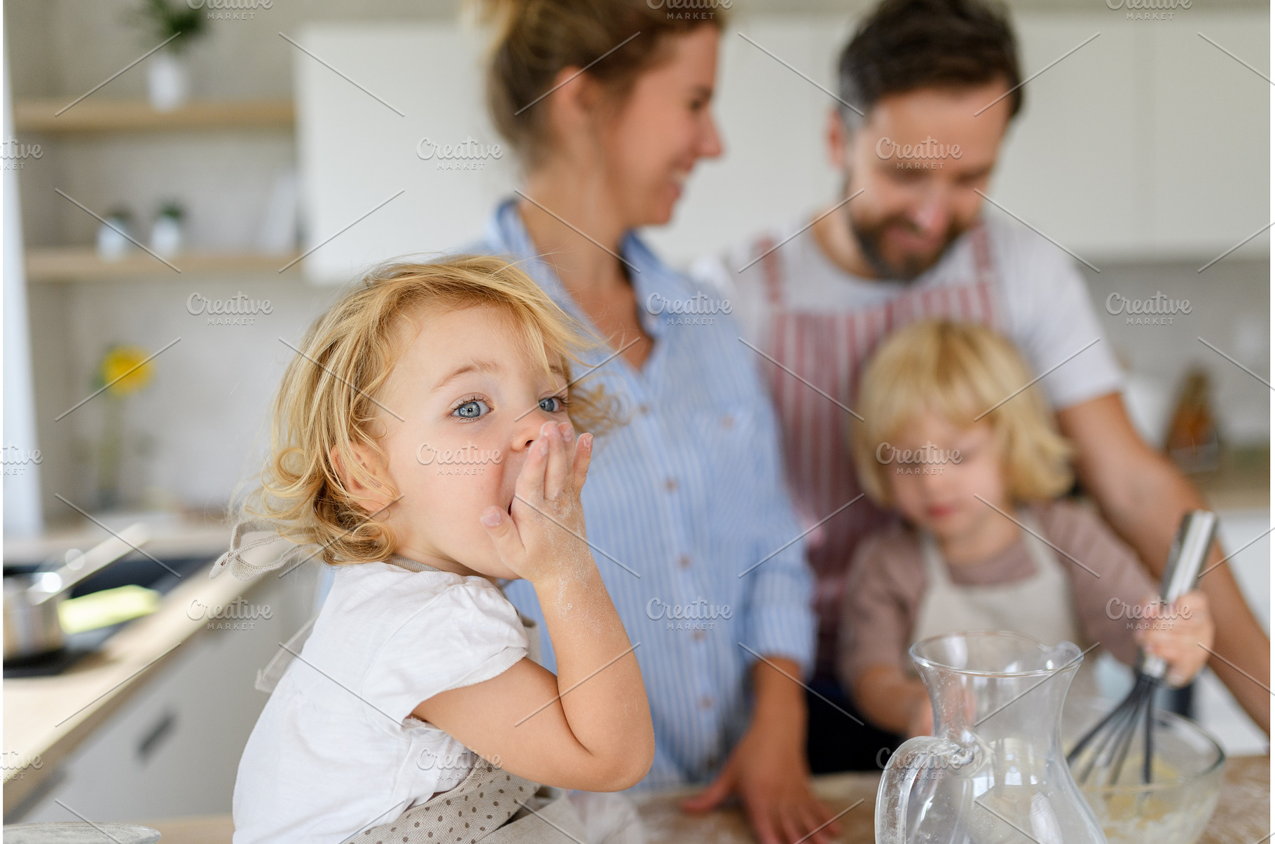 Young nuclear family making pancakes, a Person Photo by HalfPoint