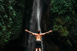 Man at the waterfall travel to bali containing active, activity, and adventure