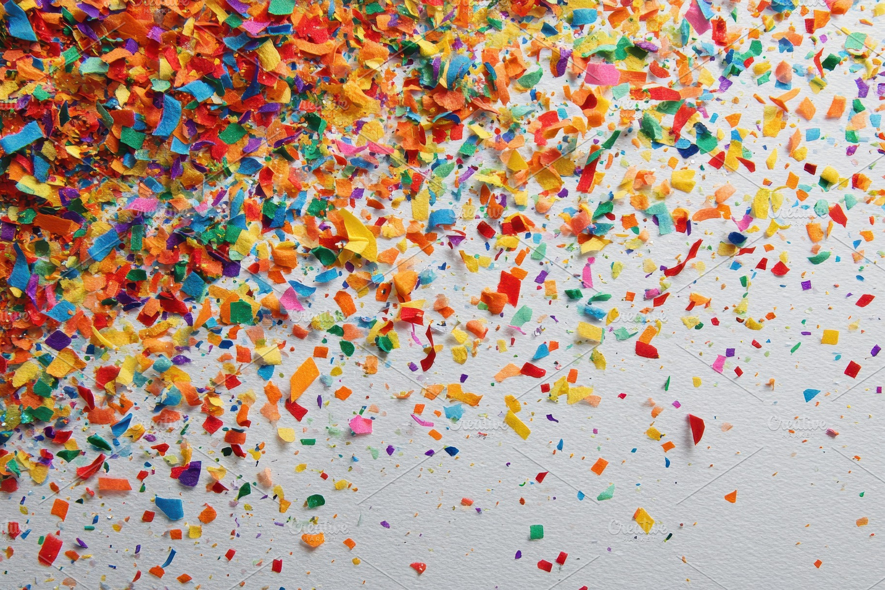 Colorful confetti scattered on white, a Photo by Pixeness Studio