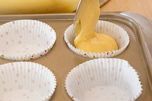 Preparing muffin treat recipe pouring batter spoon