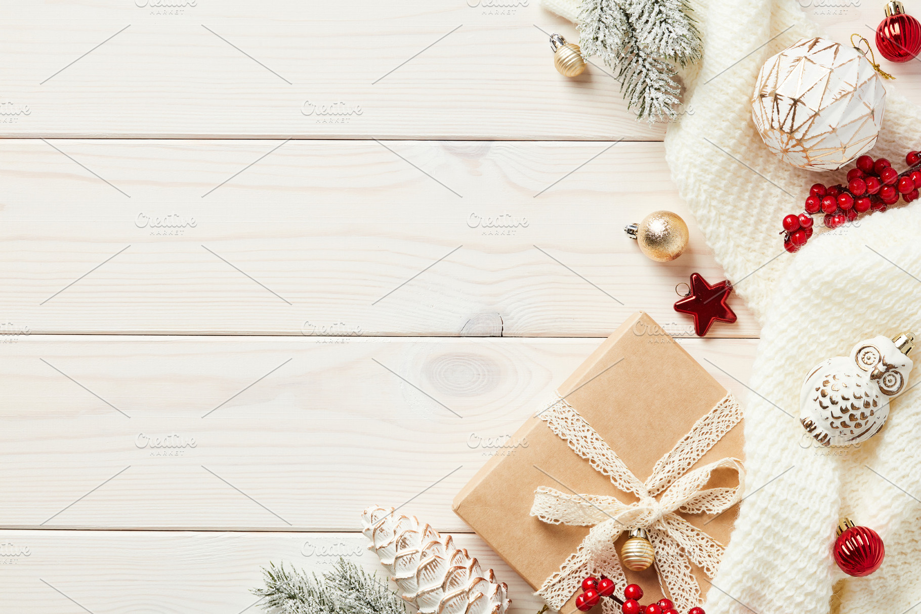 Cozy hygge wooden desk table with Christmas decorations, gift box, fir branches, a Holiday Photo by photoguns