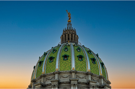 Sun sets behind the ornate dome of, an Architecture Photo by Backyard Stock