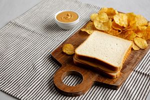 Homemade American Peanut Butter Sandwich on a Wooden Board, side, a Food & Drink Photo by LiudmylaChuhunova