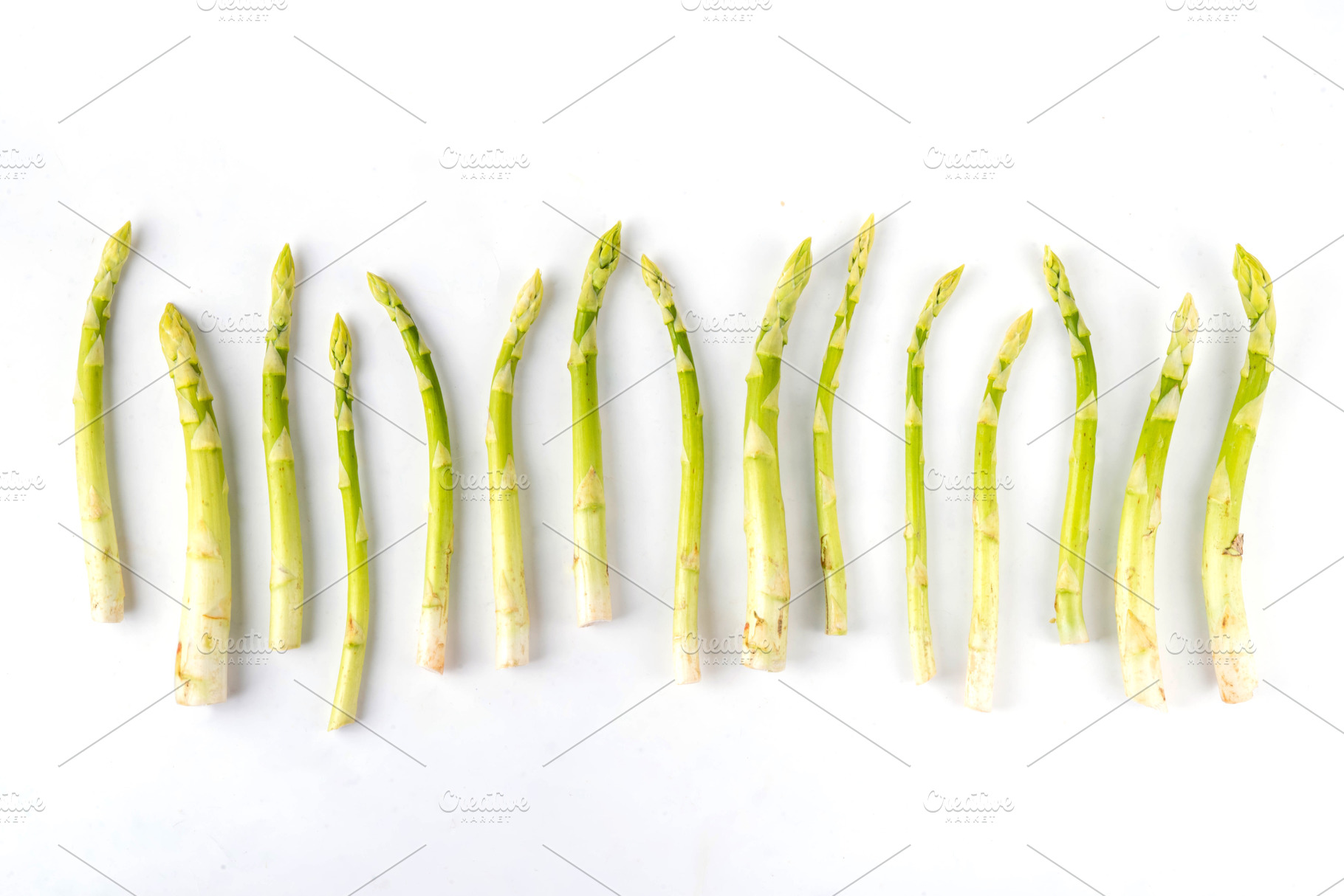 Raw fresh organic asparagus on white background, a Food & Drink Photo by Rimma