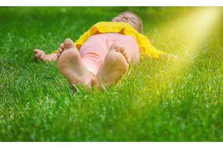 The child lies on the grass, a Person Photo by yanadjana