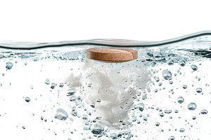 White round effervescent soluble pill falling in the water, a Health & Medical Photo by AlyaAnd