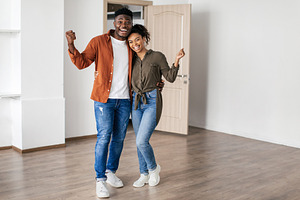 Joyful Black Couple Gesturing Yes Celebrating Moving To New Home, a Photo by Prostock-Studio