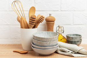 Kitchen utensils, bowls and ingredients resting on wooden counte, a Food & Drink Photo by Olena Rudo