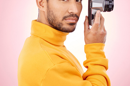 Portrait, man and retro camera for creative photography or taking a picture for art, travel or record of a memory. Serious, creative photographer and shooting on vintage film technology in studio, a Photo by Peopleimages.com